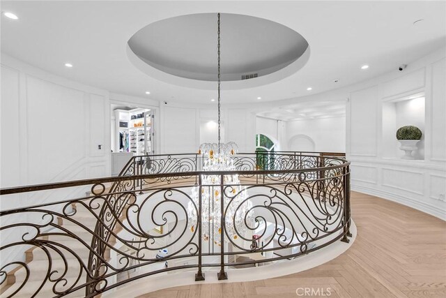 25548 Kingston Ct, Calabasas, CA 91302 - hall featuring a decorative wall, an upstairs landing, a chandelier, recessed lighting, and a tray ceiling