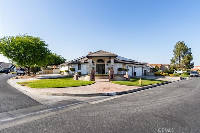 18016 Mariner Dr, Victorville, CA 92395 - mediterranean / spanish home with driveway, a garage, roof mounted solar panels, stucco siding, and a chimney
