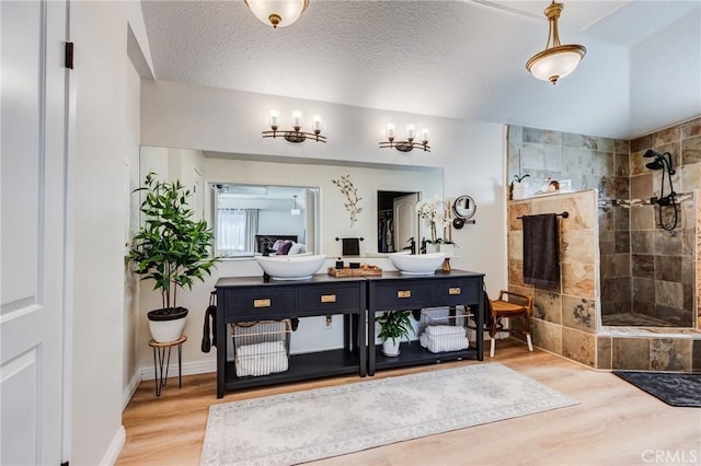 18016 Mariner Dr, Victorville, CA 92395 - full bath featuring vanity, wood finished floors, walk in shower, and a textured ceiling