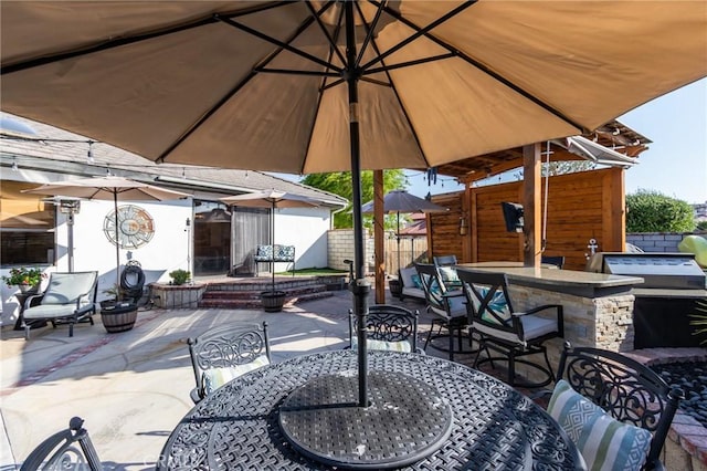 18016 Mariner Dr, Victorville, CA 92395 - view of patio / terrace featuring outdoor dining space, an outdoor bar, and an outdoor kitchen