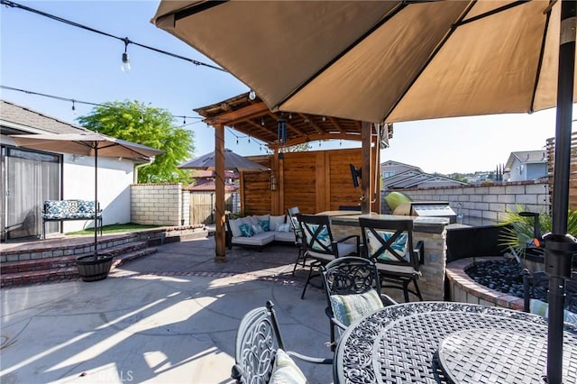 18016 Mariner Dr, Victorville, CA 92395 - fenced backyard featuring area for grilling, outdoor dining area, a patio, and an outdoor hangout area