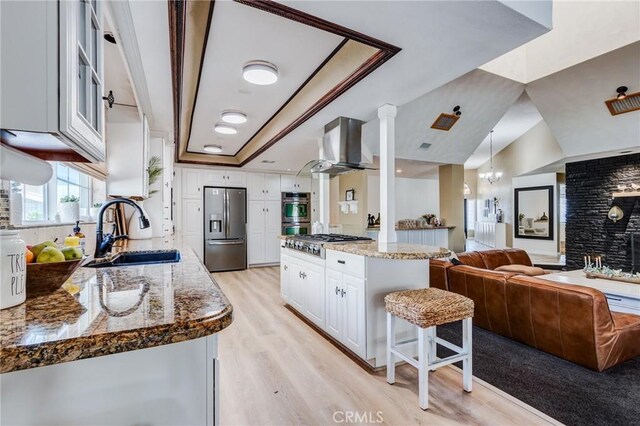 18016 Mariner Dr, Victorville, CA 92395 - kitchen with stainless steel appliances, a sink, open floor plan, white cabinets, and light wood finished floors