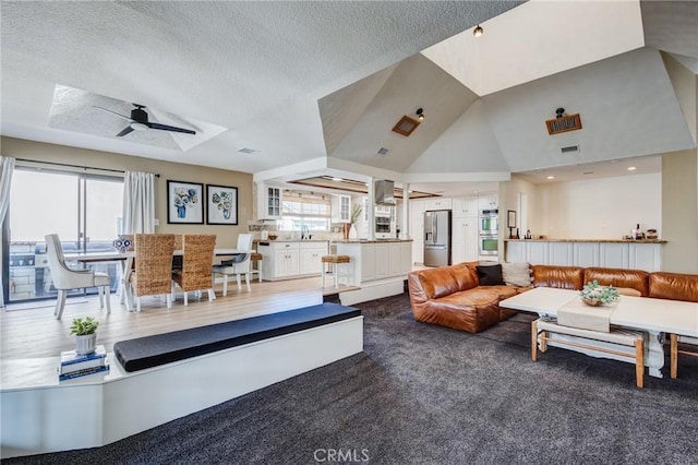 18016 Mariner Dr, Victorville, CA 92395 - carpeted living room featuring plenty of natural light, ceiling fan, a textured ceiling, and a sink