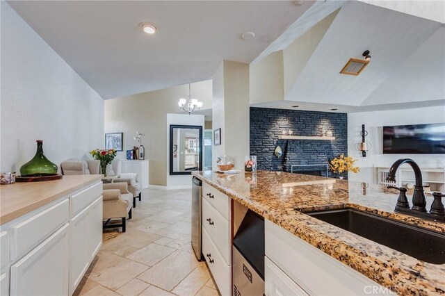 18016 Mariner Dr, Victorville, CA 92395 - kitchen with a sink, open floor plan, stone tile floors, white cabinetry, and light stone counters