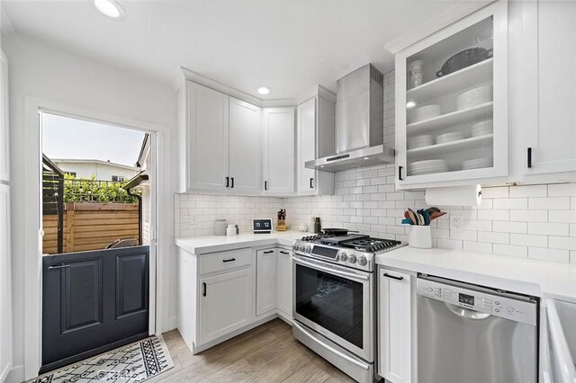 4218 E 3rd St, Long Beach, CA 90814 - kitchen with wall chimney range hood, stainless steel appliances, light countertops, and recessed lighting