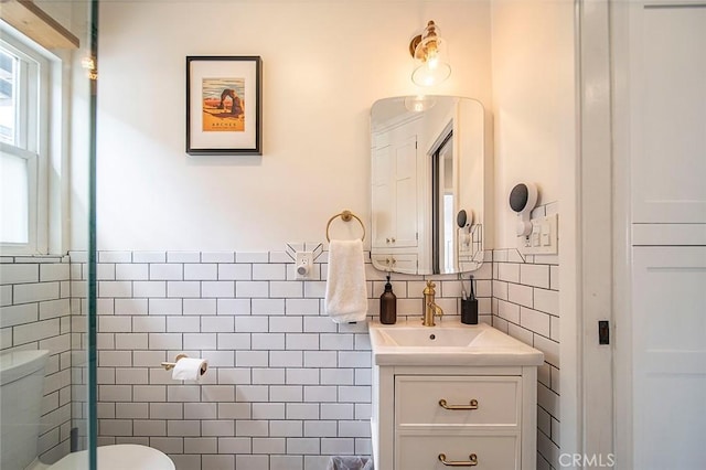 4218 E 3rd St, Long Beach, CA 90814 - bathroom with tile walls, toilet, vanity, and wainscoting