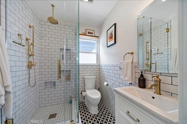 4218 E 3rd St, Long Beach, CA 90814 - bathroom with vanity, a shower stall, toilet, tile walls, and wainscoting