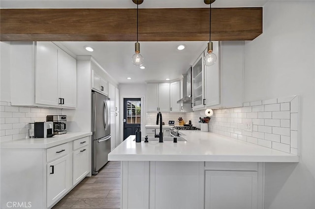 4218 E 3rd St, Long Beach, CA 90814 - kitchen with stainless steel fridge, a sink, a peninsula, tasteful backsplash, and recessed lighting
