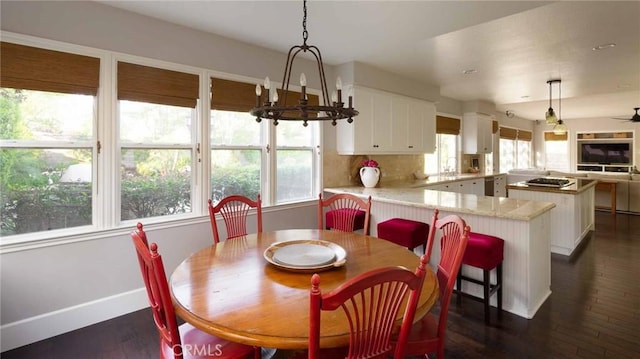 23317 Cuestport Dr, Valencia, CA 91354 - dining area featuring healthy amount of natural light, dark wood finished floors, a chandelier, and baseboards