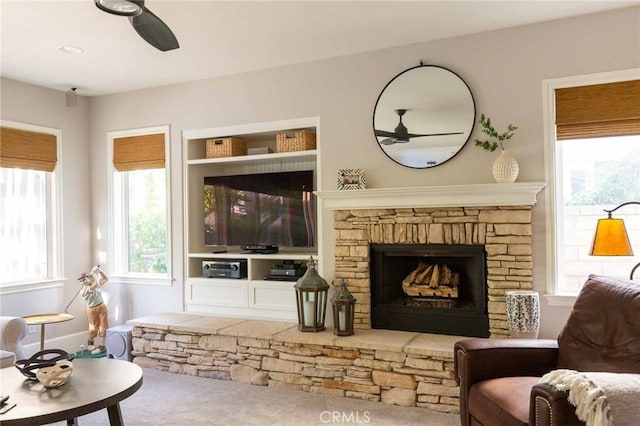 23317 Cuestport Dr, Valencia, CA 91354 - living room featuring a ceiling fan and a stone fireplace