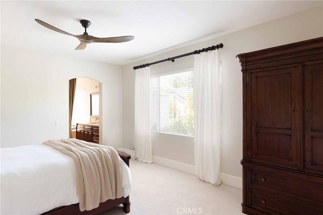 23317 Cuestport Dr, Valencia, CA 91354 - bedroom featuring arched walkways, light colored carpet, baseboards, and ceiling fan