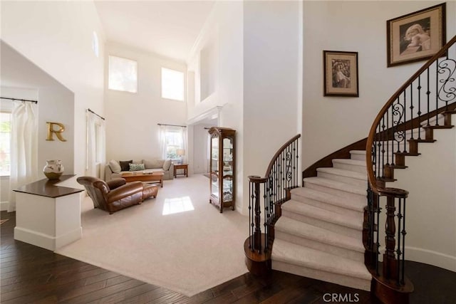 23317 Cuestport Dr, Valencia, CA 91354 - foyer featuring dark wood-style floors, stairs, baseboards, and a towering ceiling