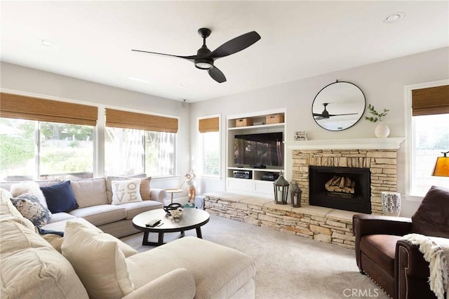 23317 Cuestport Dr, Valencia, CA 91354 - living area featuring ceiling fan, carpet, a stone fireplace, recessed lighting, and built in features