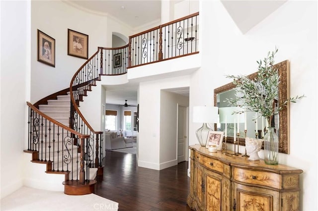 23317 Cuestport Dr, Valencia, CA 91354 - stairs featuring wood finished floors, a high ceiling, and baseboards