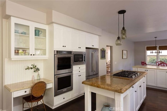 23317 Cuestport Dr, Valencia, CA 91354 - kitchen with stainless steel appliances, light stone counters, white cabinetry, and dark wood finished floors