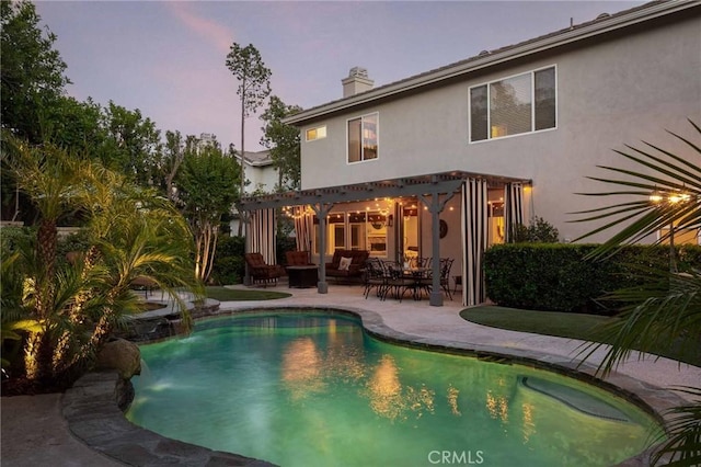 23317 Cuestport Dr, Valencia, CA 91354 - back of property featuring a patio area, stucco siding, a chimney, an outdoor living space, and an outdoor pool