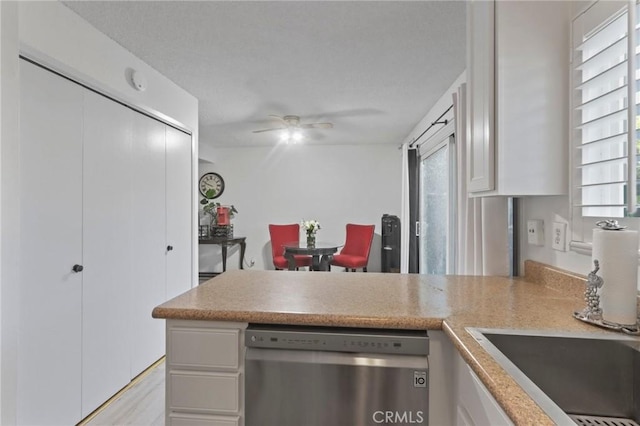 3175 Saginaw Ct, Pleasanton, CA 94588 - kitchen with dishwasher, a peninsula, a sink, white cabinets, and a ceiling fan