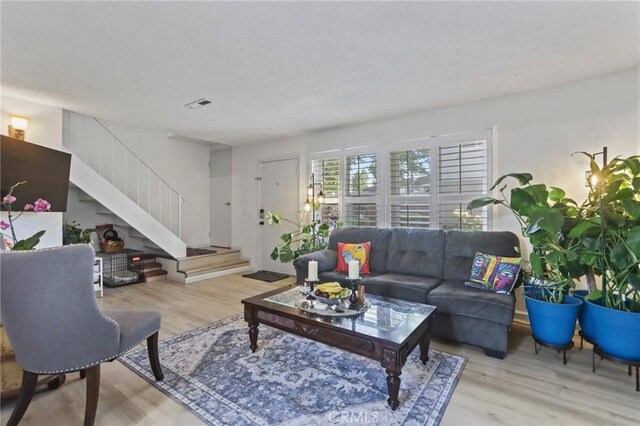 3175 Saginaw Ct, Pleasanton, CA 94588 - living area featuring wood finished floors, stairs, and a textured ceiling