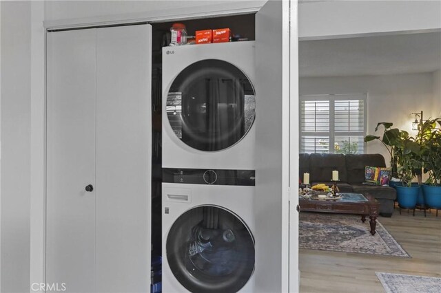 3175 Saginaw Ct, Pleasanton, CA 94588 - laundry area featuring stacked washer / drying machine and wood finished floors