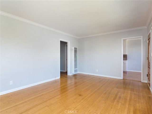 1032 W R St, Wilmington, CA 90744 - unfurnished room featuring crown molding, baseboards, a heating unit, and light wood finished floors