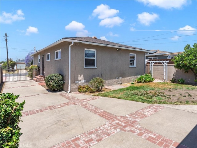 1032 W R St, Wilmington, CA 90744 - rear view of property featuring stucco siding and a patio area