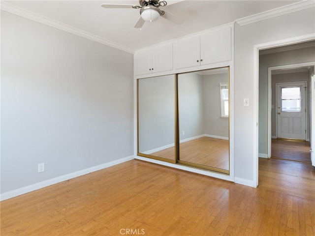 1032 W R St, Wilmington, CA 90744 - unfurnished bedroom featuring crown molding, multiple windows, light wood-style floors, baseboards, and a closet