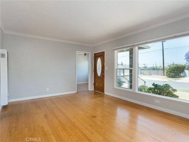 1032 W R St, Wilmington, CA 90744 - empty room with baseboards, light wood-type flooring, ornamental molding, and a heating unit