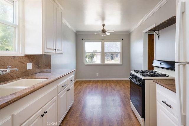 1032 W R St, Wilmington, CA 90744 - kitchen with range with gas cooktop, a sink, a ceiling fan, light wood finished floors, and white cabinets