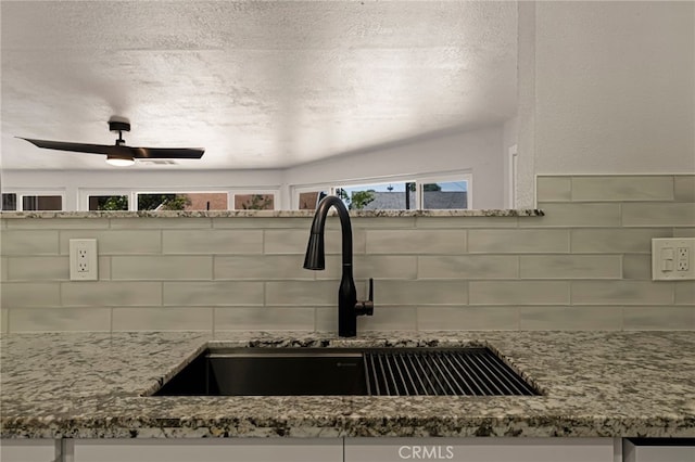 412 2nd St, Orland, CA 95963 - kitchen view of a sink, backsplash, stone countertops, and a ceiling fan