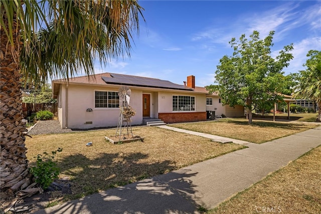 412 2nd St, Orland, CA 95963 - single story home featuring brick siding, roof mounted solar panels, stucco siding, and a chimney