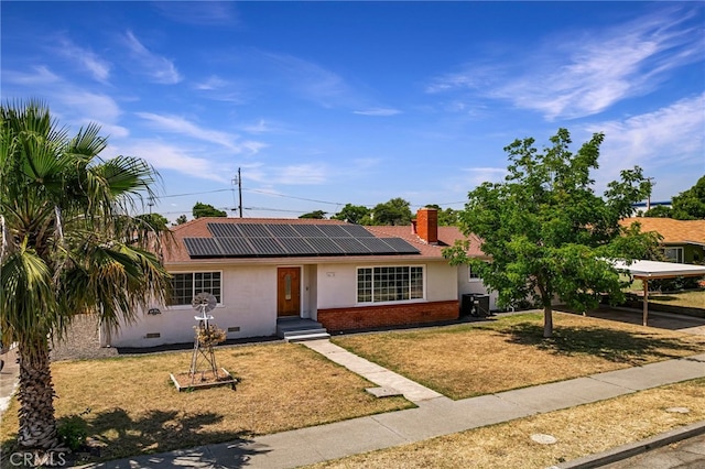 412 2nd St, Orland, CA 95963 - single story home featuring crawl space, roof mounted solar panels, a front yard, brick siding, and a chimney