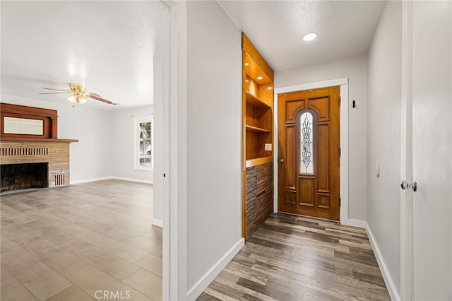 412 2nd St, Orland, CA 95963 - entryway with baseboards, ceiling fan, wood finished floors, a brick fireplace, and recessed lighting