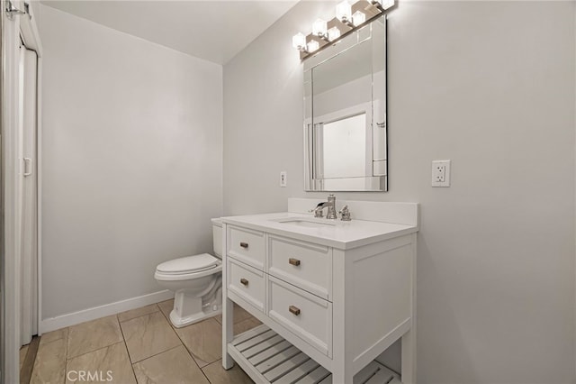 412 2nd St, Orland, CA 95963 - bathroom with vanity, toilet, marble finish flooring, and baseboards