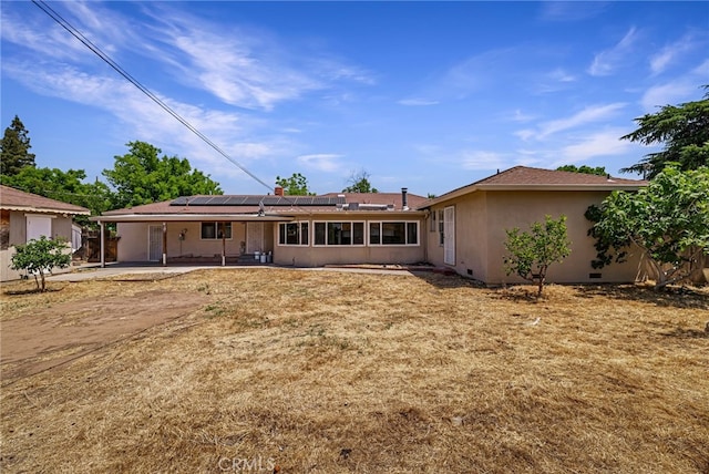 412 2nd St, Orland, CA 95963 - back of house with a patio area, roof mounted solar panels, and stucco siding