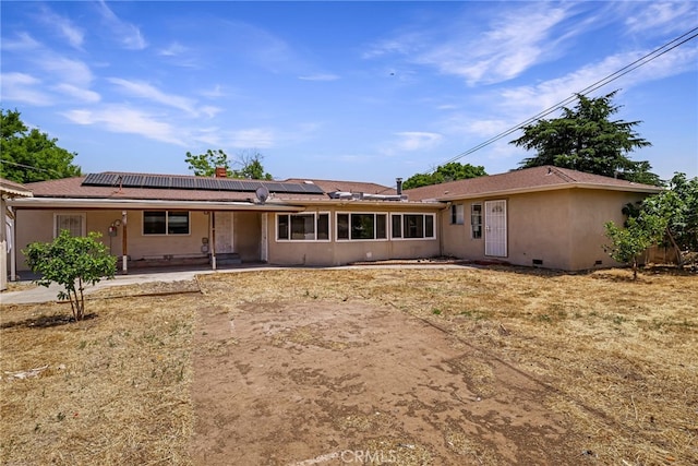 412 2nd St, Orland, CA 95963 - back of house with solar panels, stucco siding, and a patio area