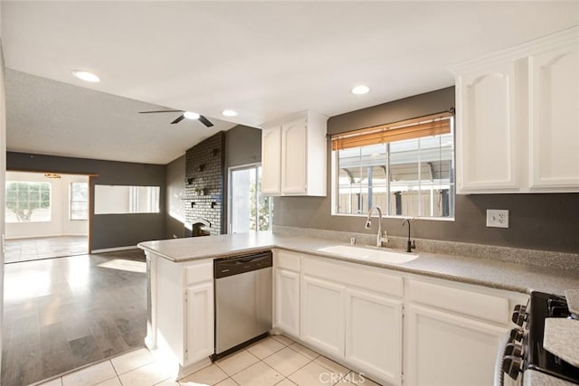 29247 Allan St, Lake Elsinore, CA 92532 - kitchen featuring appliances with stainless steel finishes, a sink, plenty of natural light, white cabinetry, and lofted ceiling