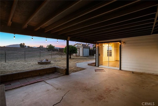 29247 Allan St, Lake Elsinore, CA 92532 - patio terrace at dusk featuring a patio, a fire pit, and a fenced backyard