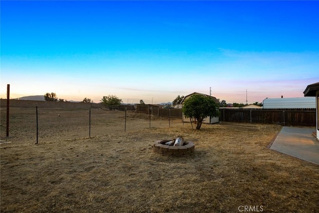 29247 Allan St, Lake Elsinore, CA 92532 - yard at dusk with a fire pit and a fenced backyard