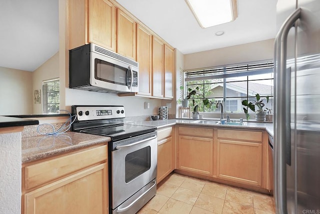3665 Grove St Unit 271, Lemon Grove, CA 91945 - kitchen featuring appliances with stainless steel finishes, light brown cabinetry, a sink, light tile patterned floors, and vaulted ceiling