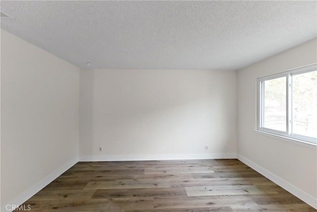 2131 W Pico Ave, Fresno, CA 93705 - empty room with a textured ceiling, wood finished floors, and baseboards