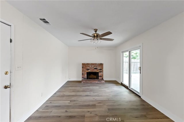 2131 W Pico Ave, Fresno, CA 93705 - unfurnished living room featuring a ceiling fan, a fireplace, wood finished floors, and baseboards