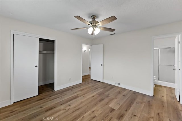 2131 W Pico Ave, Fresno, CA 93705 - unfurnished bedroom with baseboards, a closet, light wood-type flooring, ensuite bathroom, and ceiling fan