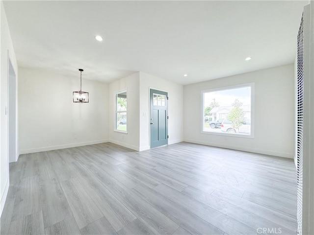 1512 S Butler Ave, Compton, CA 90221 - unfurnished living room with a chandelier, light wood-type flooring, recessed lighting, baseboards, and a heating unit