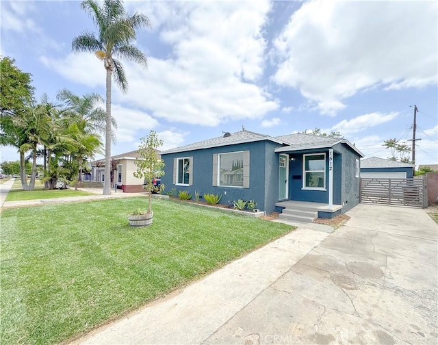1512 S Butler Ave, Compton, CA 90221 - view of front facade featuring stucco siding, a front yard, a garage, and an outdoor structure