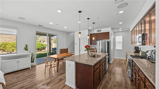 36434 Geranium Dr, Lake Elsinore, CA 92532 - kitchen featuring appliances with stainless steel finishes, a sink, dark wood finished floors, recessed lighting, and dark stone countertops