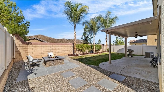 36434 Geranium Dr, Lake Elsinore, CA 92532 - fenced backyard featuring an outdoor fire pit, a ceiling fan, a patio, and central AC
