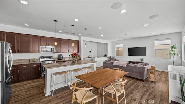 36434 Geranium Dr, Lake Elsinore, CA 92532 - kitchen with stainless steel appliances, plenty of natural light, a kitchen island, recessed lighting, and dark wood-type flooring