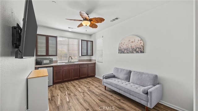 36434 Geranium Dr, Lake Elsinore, CA 92532 - bar area with a sink, stainless steel dishwasher, black microwave, light wood-type flooring, and a ceiling fan