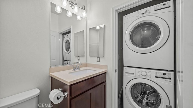 36434 Geranium Dr, Lake Elsinore, CA 92532 - bathroom with stacked washer / drying machine, toilet, and vanity