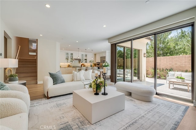 127 Toretta, Irvine, CA 92602 - living area featuring light wood finished floors, recessed lighting, and stairs
